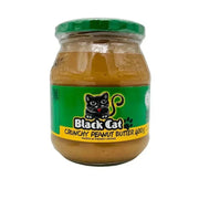 Black Cat Peanut Butter Crunchy 400g jar with roasted peanuts on a wooden surface