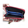 Red Cotton Road sling wallet with large white dots, zipper compartments, and removable strap.