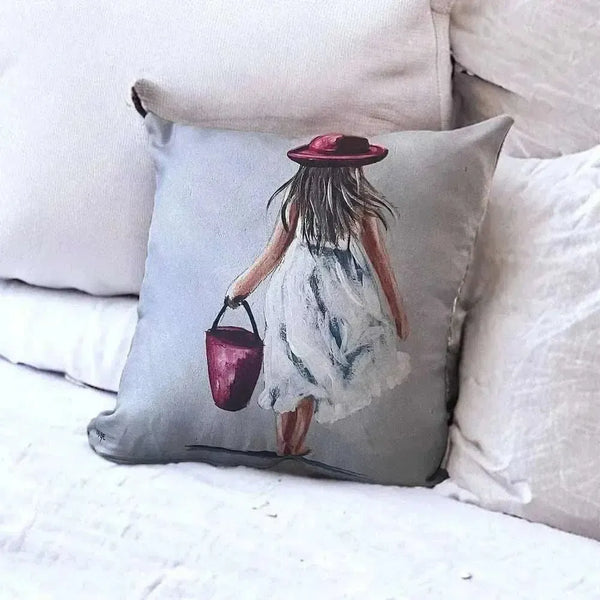 Linen cushion cover featuring South African artwork of a girl with red bucket by Inge du Preez