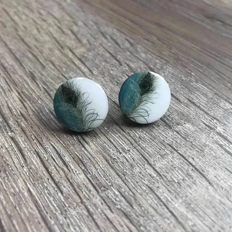White earrings with peacock feather design, 15mm diameter, sold in pairs