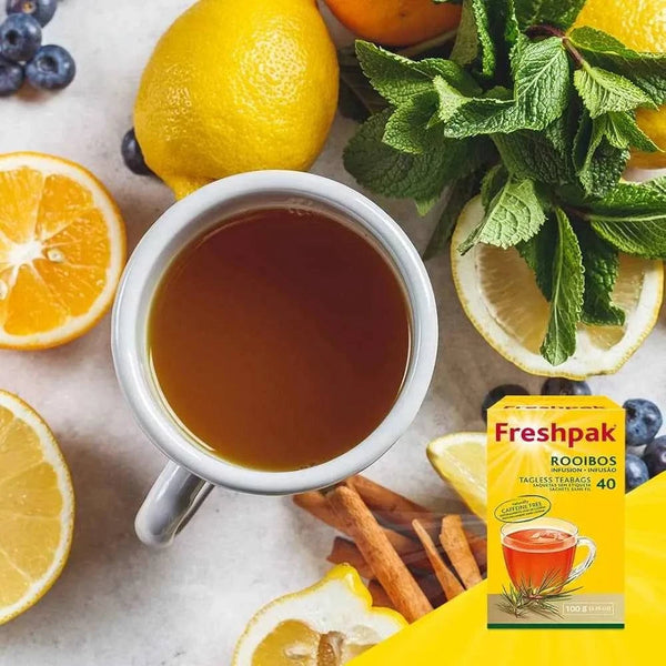 Freshpak Rooibos Tea 40's box with a cup of rooibos tea surrounded by lemon slices, mint leaves, and cinnamon sticks
