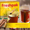 Freshpak Rooibos tea in clear glass cups with cinnamon sticks and Freshpak yellow box in background
