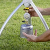 Portable CADAC Skottel Braai setup on grass for outdoor gas BBQ cooking.