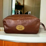 Light brown genuine leather shaving bag by Woesmooi, compact travel toiletry pouch