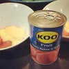 Koo Guava Halves in Syrup 410g can displayed with dessert bowls.