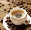 Cup of instant coffee with coffee beans on a wooden table.