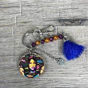 Wooden circular key tag with woman's face and navy tassel