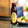 Mrs Balls Chutney Hot 470g jar on a kitchen counter, perfect for spicing up dishes.