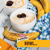 Bokomo ProNutro Original cereal in white bowls with bananas on a blue checkered cloth.