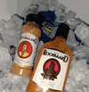 Rooibaard Spice 170ml bottle surrounded by ice, ideal for seasoning fish, chicken, pork, mutton, steak, and more.