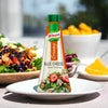 Knorr Creamy Blue Cheese Salad Dressing bottle on white plate with fresh salad background