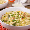 Creamy bowl of Iwisa Easy Cook Samp with mixed vegetables, ideal for side dish or porridge.
