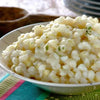 Iwisa Easy Cook Samp in a bowl, showcasing cooked, fluffy maize kernels, a South African staple.