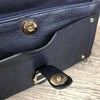 Navy PU leather sling bag with adjustable strap and multiple zip compartments