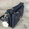 Navy PU leather sling bag with adjustable strap and multiple zip compartments