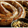 Natural hog casings for sausage making, showcasing texture and herbs, ideal for Boerewors in NZ.