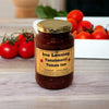 Ina Lessing Tomato Jam 500g jar with fresh tomatoes in the background, featuring a premium handcrafted condiment made from ripe tomatoes and spices.