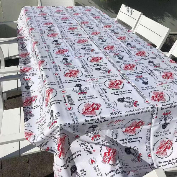 White tablecloth with Afrikaans sayings on elegant dining table setting