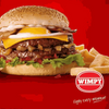 Wimpy Burger with Relish Sauce, cheese, and fries on a red background.