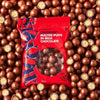 Woolworths CHUCKLES® Chocolate & Malted Puffs 250g package surrounded by crunchy chocolate-coated puffs.