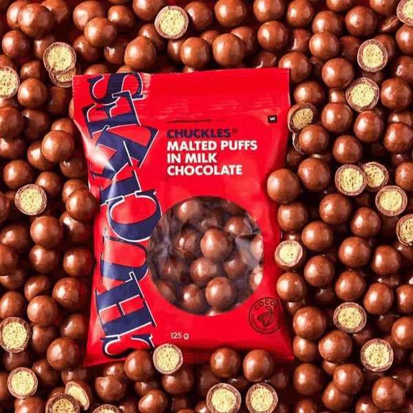 Woolworths CHUCKLES® Chocolate & Malted Puffs 250g package surrounded by crunchy chocolate-coated puffs.